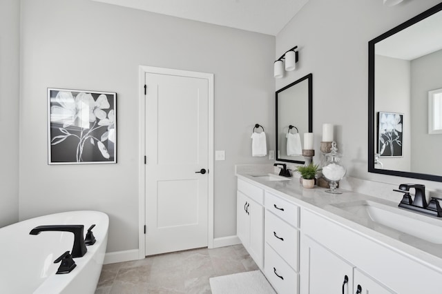 bathroom featuring tile patterned flooring, vanity, and a washtub