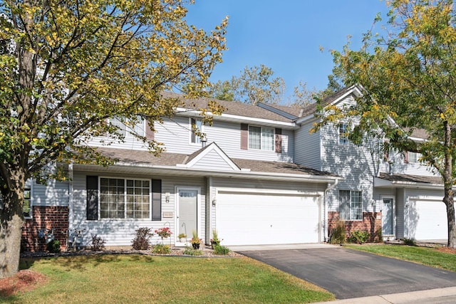 view of front of house with a garage and a front lawn