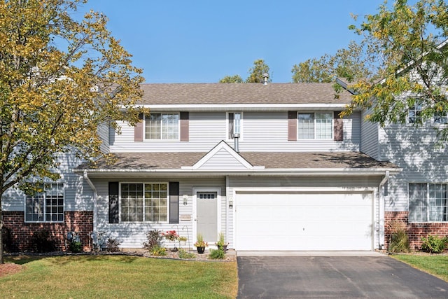 view of front facade with a front lawn and a garage