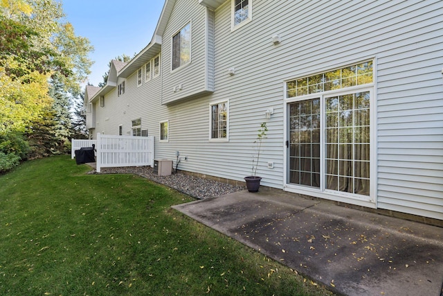 rear view of house featuring a patio and a lawn