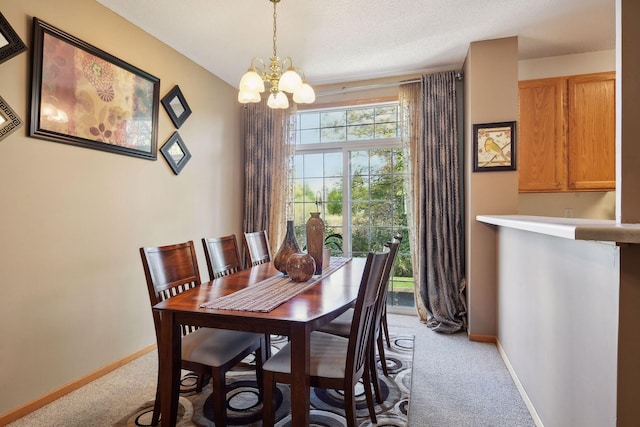 carpeted dining space featuring an inviting chandelier and a textured ceiling