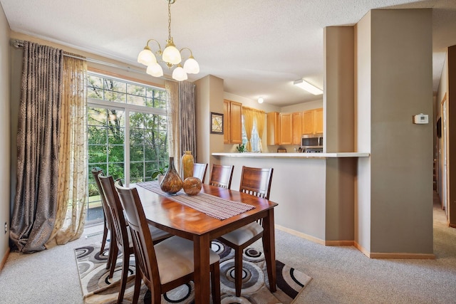 dining room featuring light carpet, an inviting chandelier, and a textured ceiling