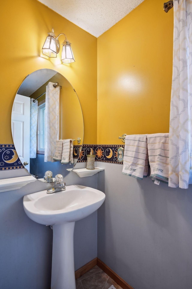 bathroom with tile patterned floors and a textured ceiling