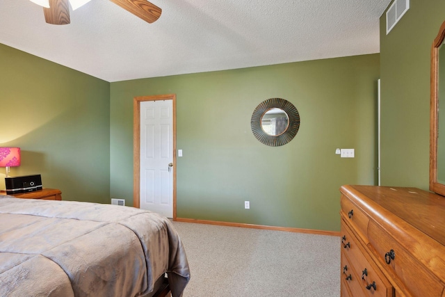 bedroom featuring ceiling fan, carpet floors, and a textured ceiling