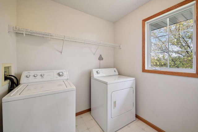 laundry area featuring a textured ceiling and washer and clothes dryer