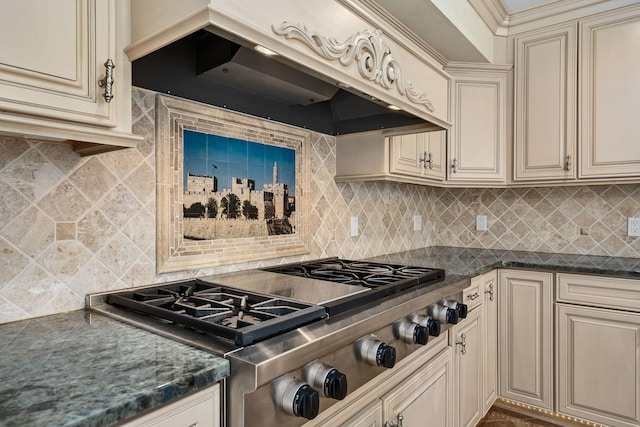 301 22nd St NW, Austin, MN 55912 - kitchen featuring cream cabinetry, stainless steel gas cooktop, custom range hood, dark countertops, and backsplash