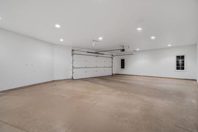 301 22nd St NW, Austin, MN 55912 - garage with a garage door opener, recessed lighting, and baseboards