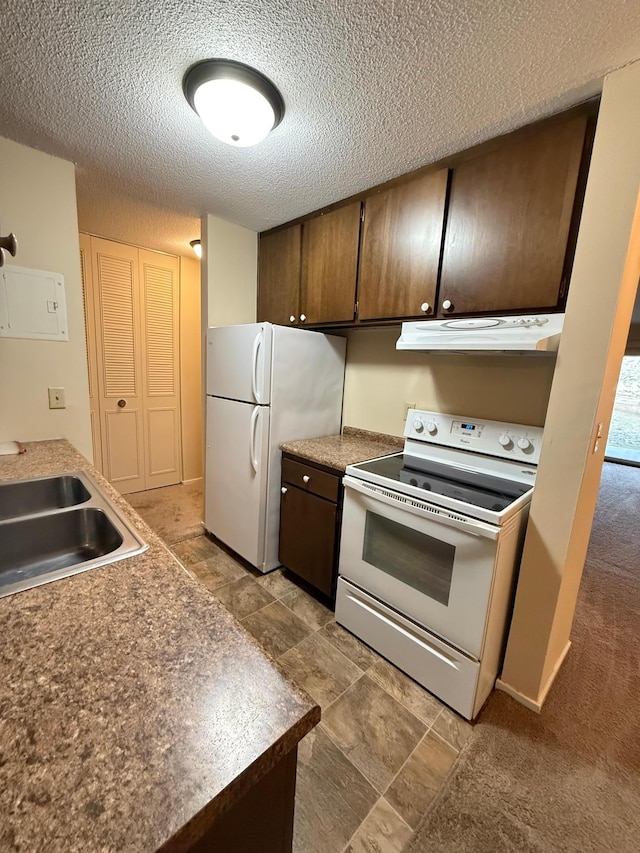 kitchen with a textured ceiling, sink, and white appliances