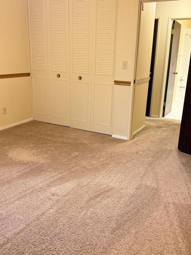 unfurnished bedroom featuring light carpet