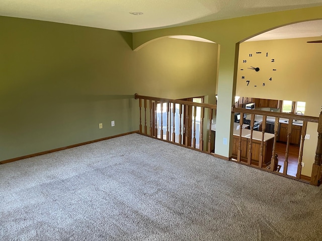 empty room featuring carpet floors, lofted ceiling, and ceiling fan