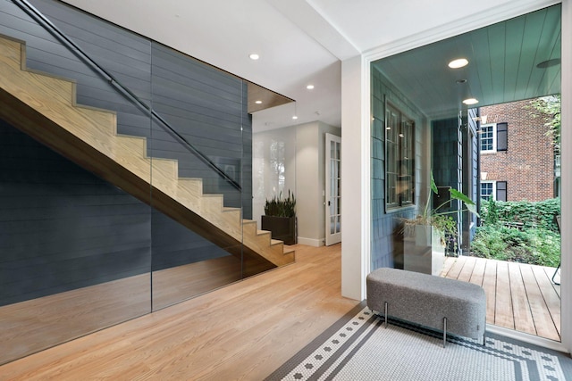 stairs featuring hardwood / wood-style floors