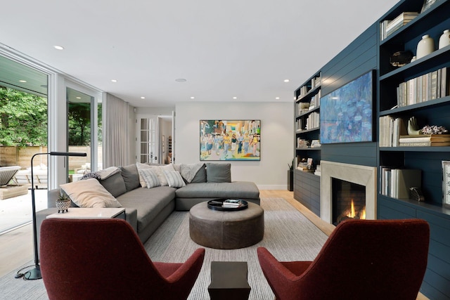 living room with expansive windows and a premium fireplace