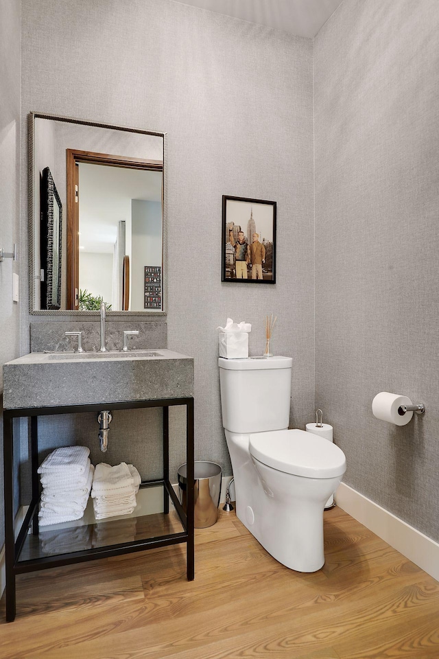 bathroom featuring sink, hardwood / wood-style flooring, and toilet