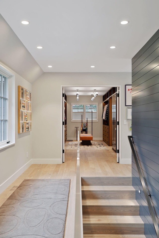 interior space with light hardwood / wood-style flooring and lofted ceiling