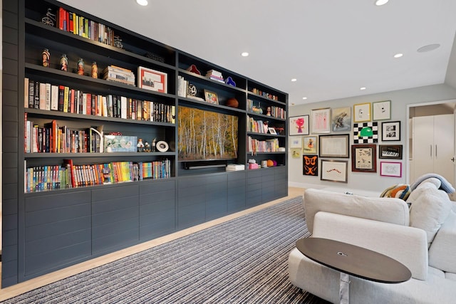 sitting room featuring carpet floors and built in features