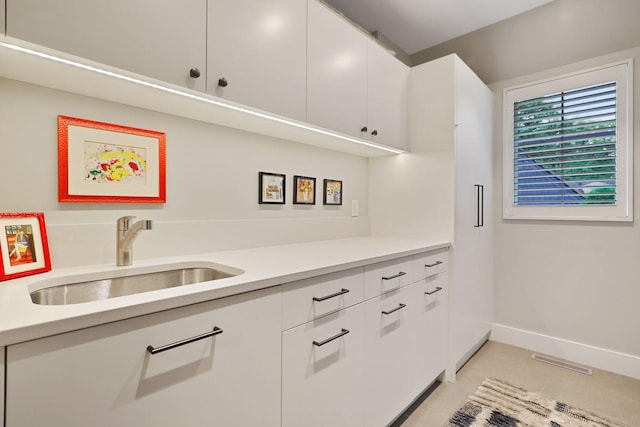 kitchen with sink and white cabinetry