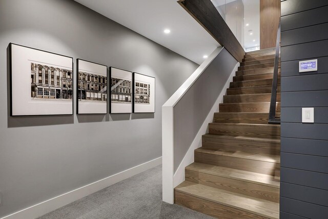 stairs featuring carpet flooring