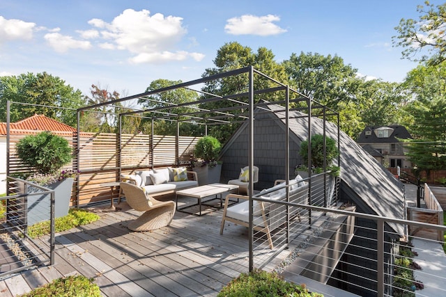 wooden terrace with an outdoor living space