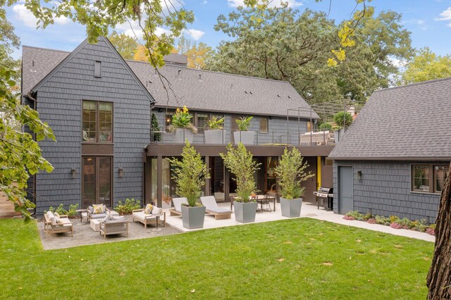 back of house with a patio, an outdoor living space, and a yard