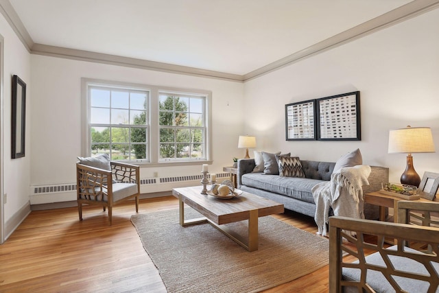 living room with ornamental molding, radiator, and light hardwood / wood-style flooring