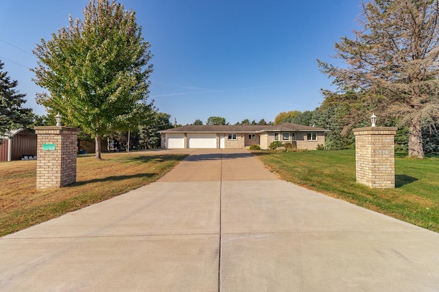 single story home with a front yard and a garage