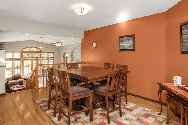 dining area with ceiling fan, lofted ceiling, and light hardwood / wood-style floors