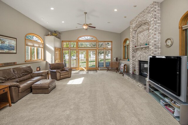 carpeted living room featuring a fireplace, plenty of natural light, french doors, and ceiling fan