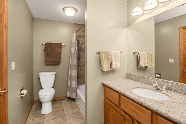 full bathroom featuring shower / bath combo, vanity, tile patterned flooring, and toilet