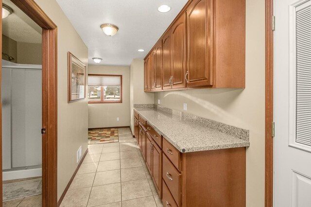 kitchen featuring light stone counters and light tile patterned floors