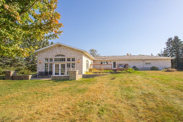 rear view of house featuring a yard and a patio area