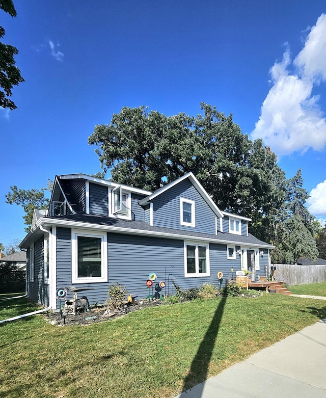 front facade featuring a deck and a front lawn