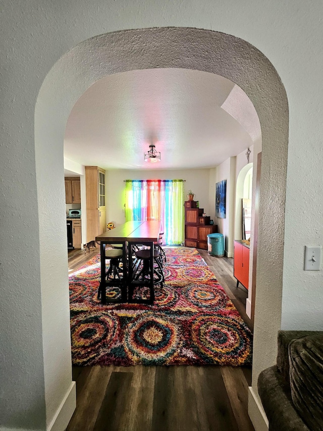 dining area with a textured ceiling and hardwood / wood-style flooring