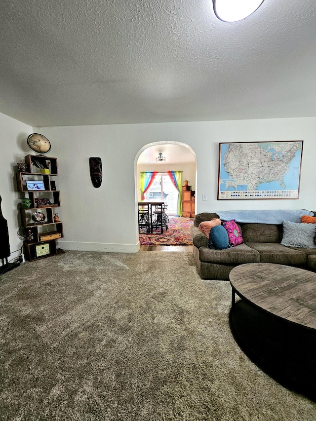 living room with a textured ceiling and carpet flooring