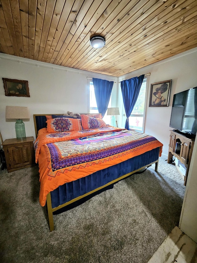 carpeted bedroom featuring ornamental molding, multiple windows, and wooden ceiling