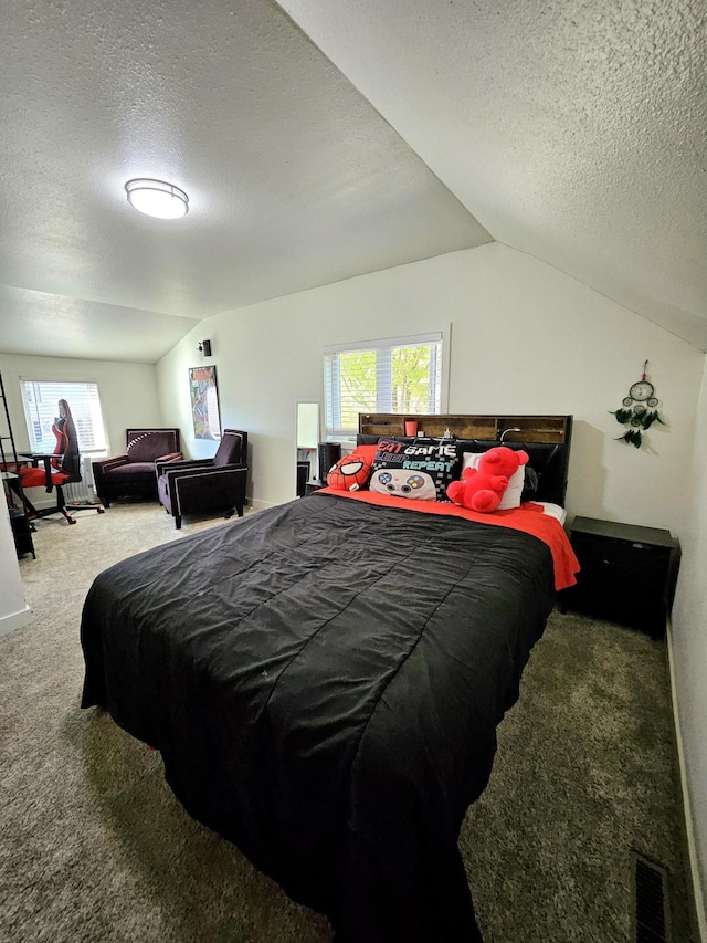 bedroom featuring a textured ceiling, vaulted ceiling, and carpet