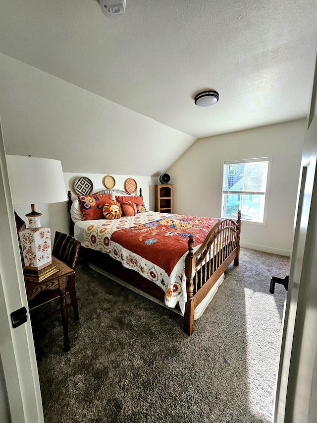 bedroom with carpet, lofted ceiling, and a textured ceiling