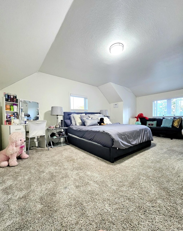 bedroom featuring carpet floors, vaulted ceiling, and multiple windows