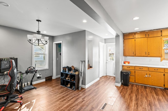 interior space with dark wood-type flooring and an inviting chandelier