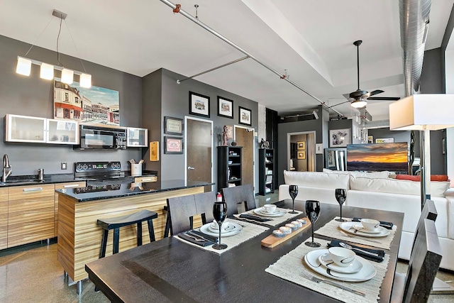 dining area with sink and ceiling fan