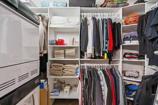 walk in closet featuring stacked washer / dryer