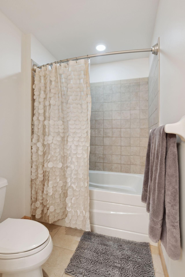 full bathroom featuring toilet, shower / bath combination with curtain, and tile patterned floors