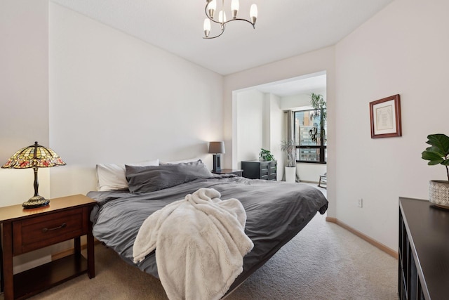 bedroom with a chandelier, light colored carpet, and baseboards