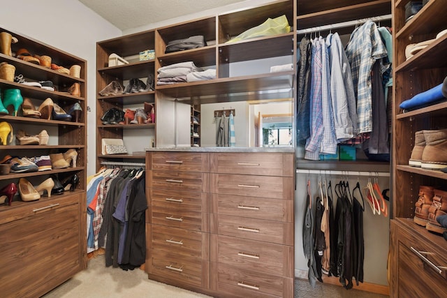 walk in closet featuring light colored carpet