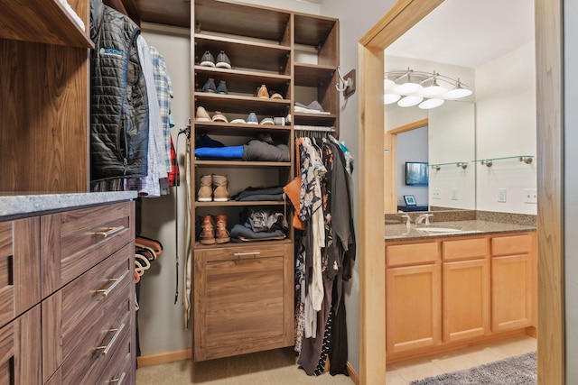 walk in closet with a sink