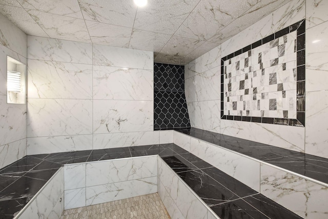 bathroom with a tile shower