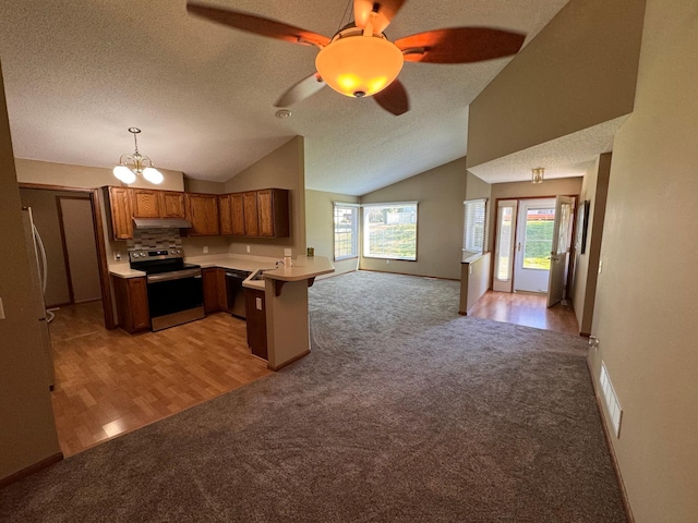 kitchen featuring light hardwood / wood-style floors, kitchen peninsula, a kitchen breakfast bar, and stainless steel electric range