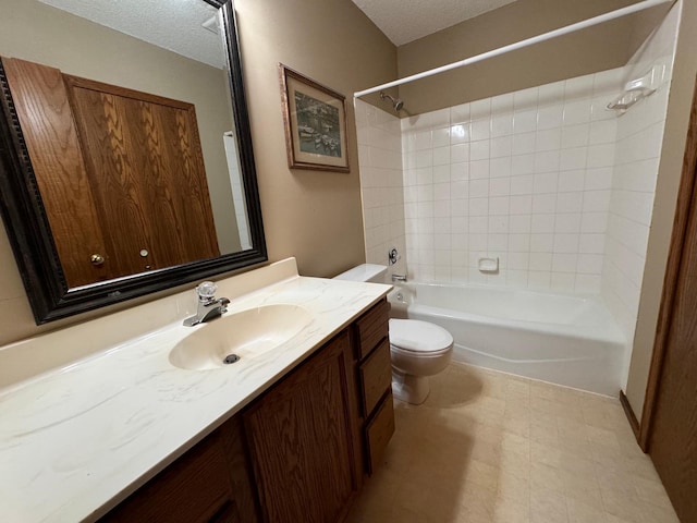 full bathroom with a textured ceiling, tiled shower / bath combo, vanity, and toilet