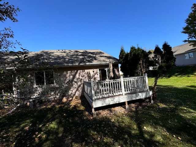 wooden deck featuring a yard