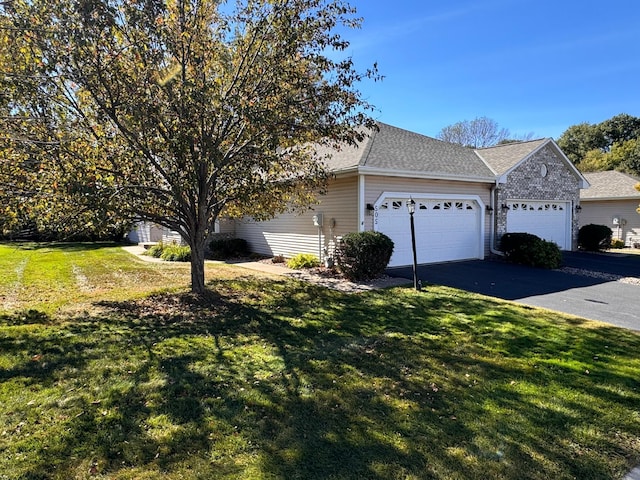 view of home's exterior featuring a yard and a garage