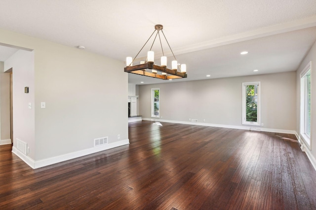 interior space featuring dark hardwood / wood-style flooring and a textured ceiling